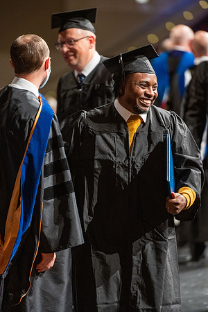 Combined Convocation for the College of Business & Communication and also the College of Physical Sciences & Engineering. Graduates receive their diploma covers.