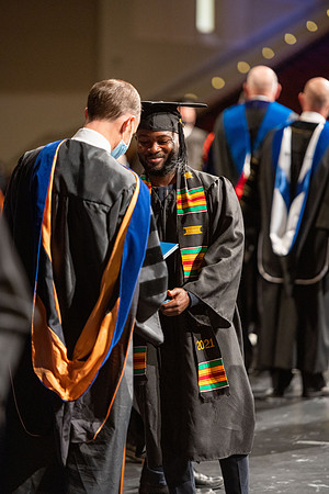 Combined Convocation for the College of Business & Communication and also the College of Physical Sciences & Engineering. Graduates receive their diploma covers.