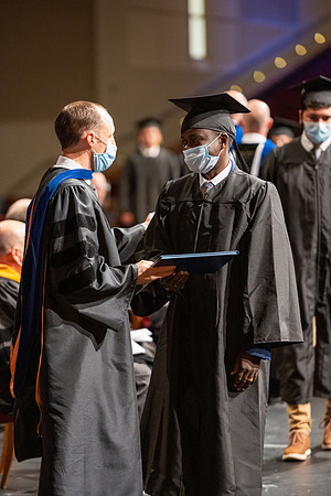 Combined Convocation for the College of Business & Communication and also the College of Physical Sciences & Engineering. Graduates receive their diploma covers.