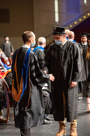 Combined Convocation for the College of Business & Communication and also the College of Physical Sciences & Engineering. Graduates receive their diploma covers.