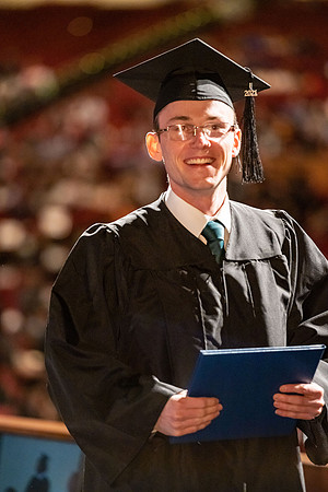 Combined Convocation for the College of Business & Communication and also the College of Physical Sciences & Engineering. Graduates receive their diploma covers.