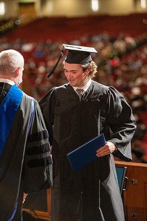 Combined Convocation for the College of Business & Communication and also the College of Physical Sciences & Engineering. Graduates receive their diploma covers.