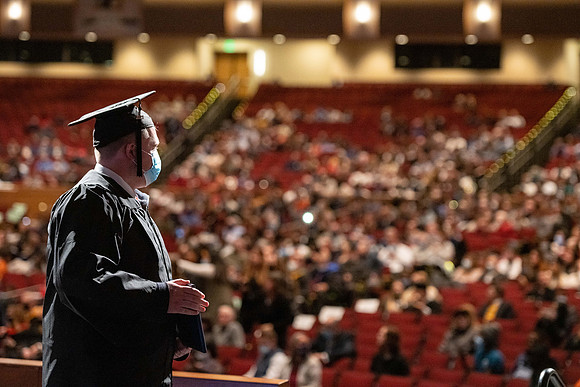 Combined Convocation for the College of Business & Communication and also the College of Physical Sciences & Engineering. Graduates receive their diploma covers.
