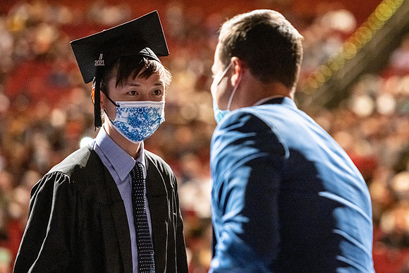 Combined Convocation for the College of Business & Communication and also the College of Physical Sciences & Engineering. Graduates receive their diploma covers.