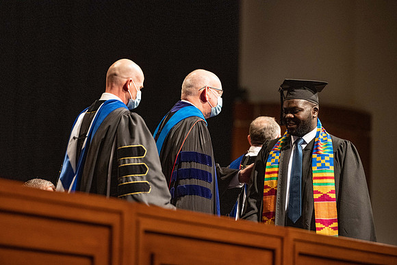 Combined Convocation for the College of Business & Communication and also the College of Physical Sciences & Engineering. Graduates receive their diploma covers.