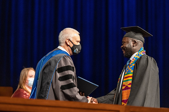 Combined Convocation for the College of Business & Communication and also the College of Physical Sciences & Engineering. Graduates receive their diploma covers.