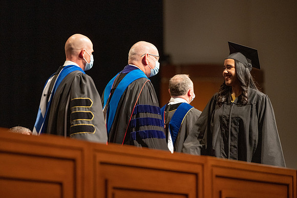 Combined Convocation for the College of Business & Communication and also the College of Physical Sciences & Engineering. Graduates receive their diploma covers.