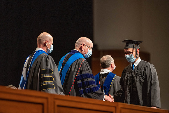 Combined Convocation for the College of Business & Communication and also the College of Physical Sciences & Engineering. Graduates receive their diploma covers.