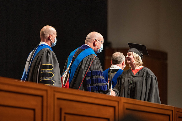 Combined Convocation for the College of Business & Communication and also the College of Physical Sciences & Engineering. Graduates receive their diploma covers.