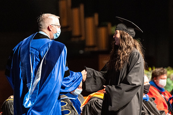 Combined Convocation for the College of Business & Communication and also the College of Physical Sciences & Engineering. Graduates receive their diploma covers.
