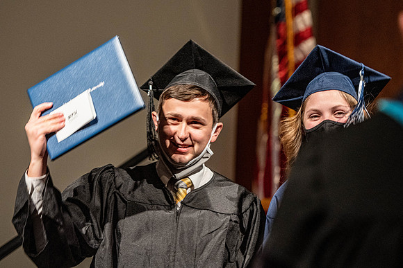 Combined Convocation for the College of Business & Communication and also the College of Physical Sciences & Engineering. Graduates receive their diploma covers.