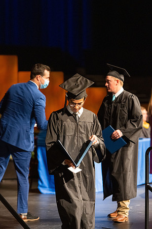 Combined Convocation for the College of Business & Communication and also the College of Physical Sciences & Engineering. Graduates receive their diploma covers.
