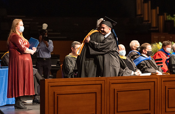 Combined Convocation for the College of Business & Communication and also the College of Physical Sciences & Engineering. Graduates receive their diploma covers.