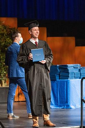Combined Convocation for the College of Business & Communication and also the College of Physical Sciences & Engineering. Graduates receive their diploma covers.