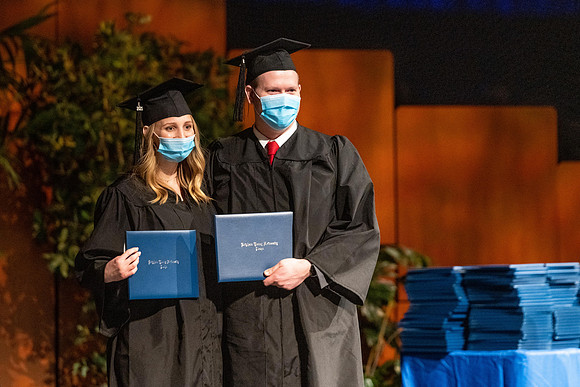 Combined Convocation for the College of Business & Communication and also the College of Physical Sciences & Engineering. Graduates receive their diploma covers.