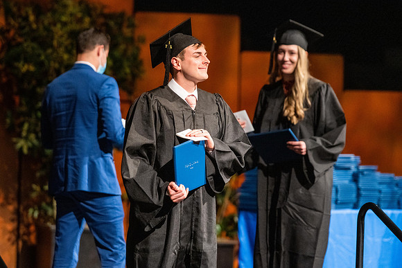 Combined Convocation for the College of Business & Communication and also the College of Physical Sciences & Engineering. Graduates receive their diploma covers.
