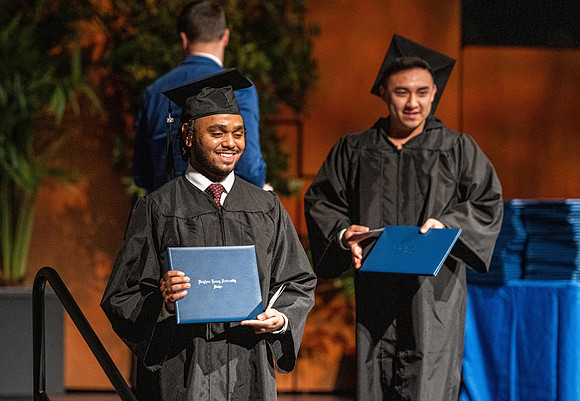 Combined Convocation for the College of Business & Communication and also the College of Physical Sciences & Engineering. Graduates receive their diploma covers.