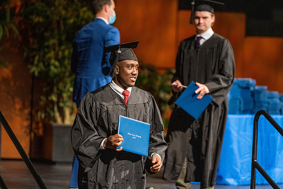 Combined Convocation for the College of Business & Communication and also the College of Physical Sciences & Engineering. Graduates receive their diploma covers.