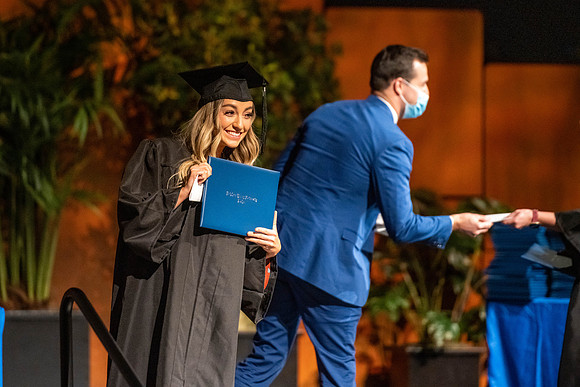 Combined Convocation for the College of Business & Communication and also the College of Physical Sciences & Engineering. Graduates receive their diploma covers.