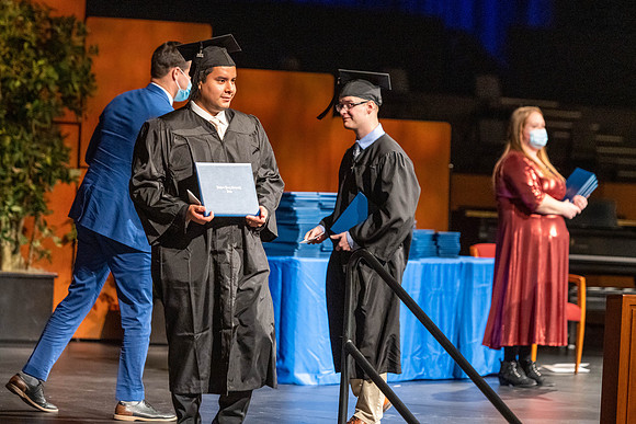 Combined Convocation for the College of Business & Communication and also the College of Physical Sciences & Engineering. Graduates receive their diploma covers.