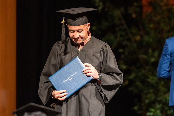 Combined Convocation for the College of Business & Communication and also the College of Physical Sciences & Engineering. Graduates receive their diploma covers.