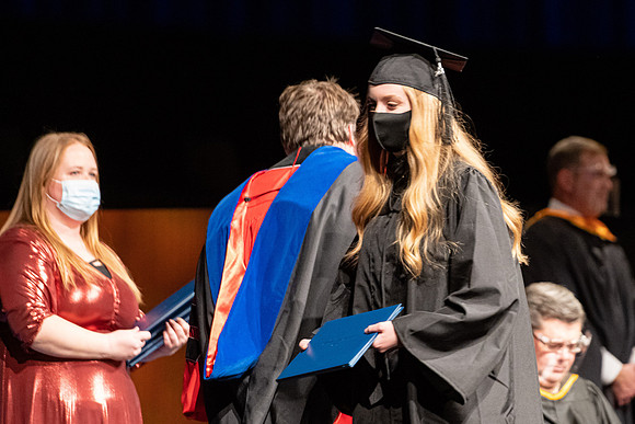 Combined Convocation for the College of Business & Communication and also the College of Physical Sciences & Engineering. Graduates receive their diploma covers.