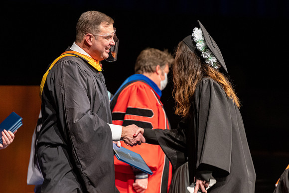 Combined Convocation for the College of Business & Communication and also the College of Physical Sciences & Engineering. Graduates receive their diploma covers.