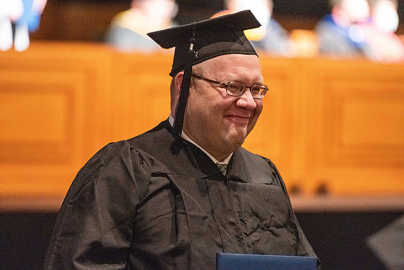 Combined Convocation for the College of Business & Communication and also the College of Physical Sciences & Engineering. Graduates receive their diploma covers.