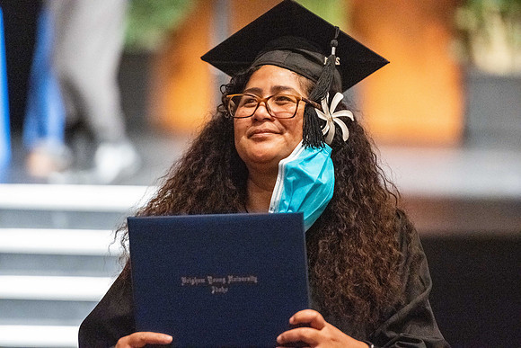 Combined Convocation for the College of Business & Communication and also the College of Physical Sciences & Engineering. Graduates receive their diploma covers.