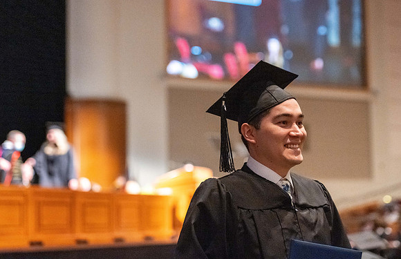 Combined Convocation for the College of Business & Communication and also the College of Physical Sciences & Engineering. Graduates receive their diploma covers.