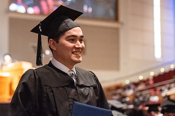 Combined Convocation for the College of Business & Communication and also the College of Physical Sciences & Engineering. Graduates receive their diploma covers.