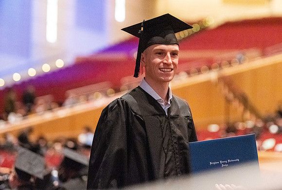 Combined Convocation for the College of Business & Communication and also the College of Physical Sciences & Engineering. Graduates receive their diploma covers.