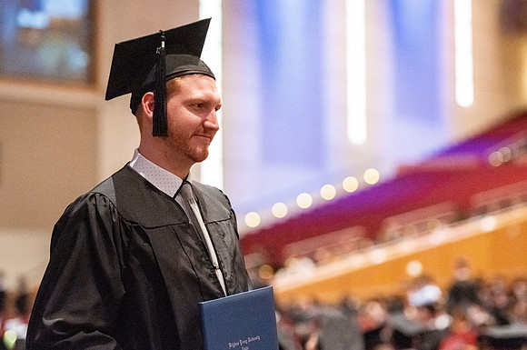 Combined Convocation for the College of Business & Communication and also the College of Physical Sciences & Engineering. Graduates receive their diploma covers.