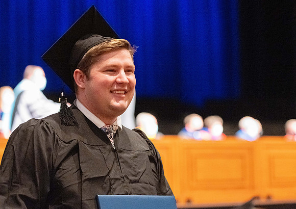 Combined Convocation for the College of Business & Communication and also the College of Physical Sciences & Engineering. Graduates receive their diploma covers.