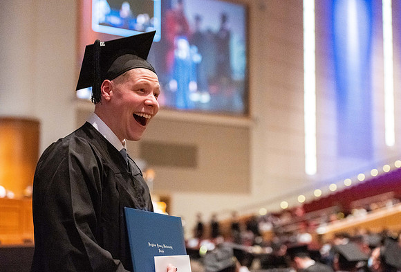 Combined Convocation for the College of Business & Communication and also the College of Physical Sciences & Engineering. Graduates receive their diploma covers.