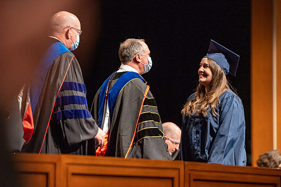 Combined Convocation for the College of Business & Communication and also the College of Physical Sciences & Engineering. Graduates receive their diploma covers.