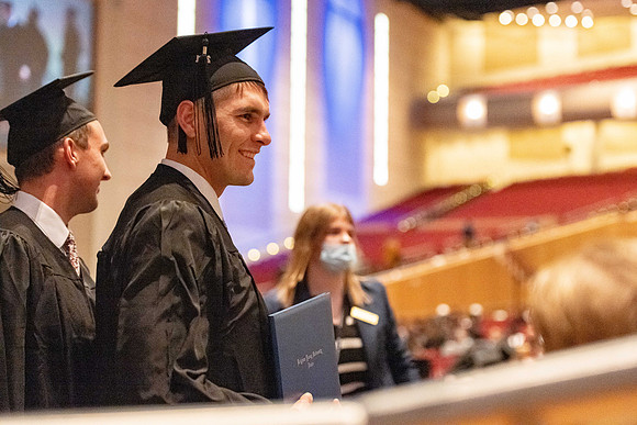 Combined Convocation for the College of Business & Communication and also the College of Physical Sciences & Engineering. Graduates receive their diploma covers.