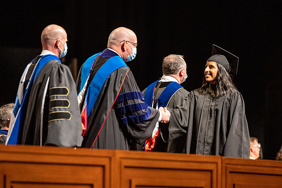 Combined Convocation for the College of Business & Communication and also the College of Physical Sciences & Engineering. Graduates receive their diploma covers.