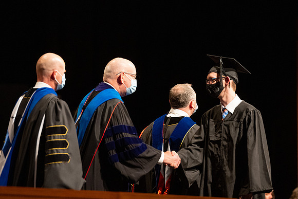 Combined Convocation for the College of Business & Communication and also the College of Physical Sciences & Engineering. Graduates receive their diploma covers.