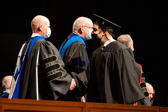 Combined Convocation for the College of Business & Communication and also the College of Physical Sciences & Engineering. Graduates receive their diploma covers.