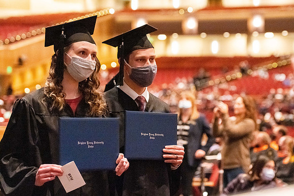 Combined Convocation for the College of Business & Communication and also the College of Physical Sciences & Engineering. Graduates receive their diploma covers.