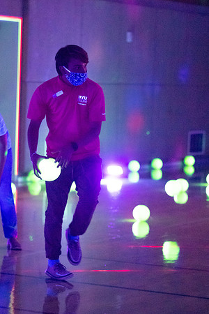 Examples of students staying safe and healthy during the COVID-19 pandemic by social distancing, following pathway arrows, and wearing face masks during activities.
