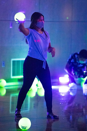 Examples of students staying safe and healthy during the COVID-19 pandemic by social distancing, following pathway arrows, and wearing face masks during activities.
