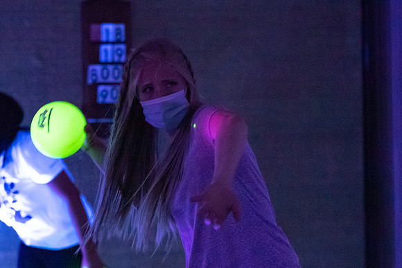 Examples of students staying safe and healthy during the COVID-19 pandemic by social distancing, following pathway arrows, and wearing face masks during activities.