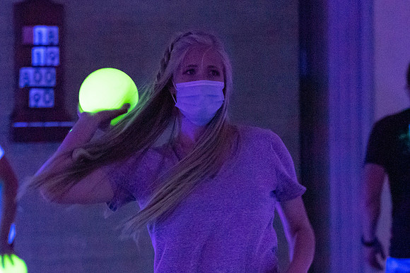 Examples of students staying safe and healthy during the COVID-19 pandemic by social distancing, following pathway arrows, and wearing face masks during activities.