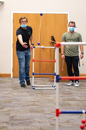 Examples of students staying safe and healthy during the COVID-19 pandemic by social distancing, following pathway arrows, and wearing face masks during activities.