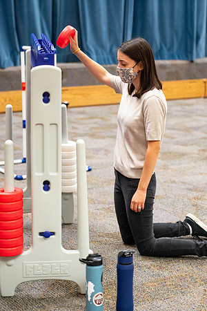 Examples of students staying safe and healthy during the COVID-19 pandemic by social distancing, following pathway arrows, and wearing face masks during activities.