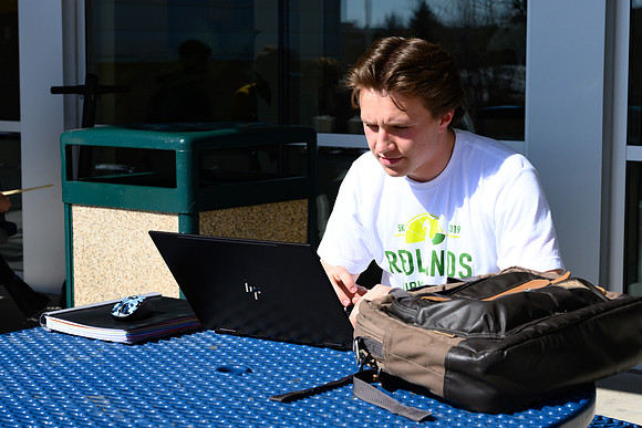 Students studying outside on the first warmer day of the year.