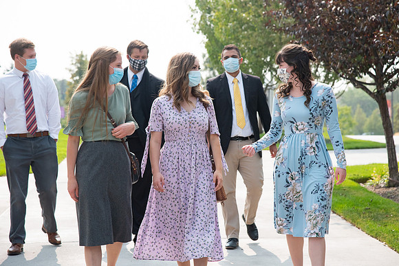 Students going to church on campus with face masks.