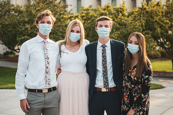Students stay safe wearing masks and social distancing in their sunday best.